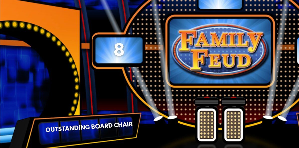 Board Chair - Family Feud stage with two podiums, Outstanding Board Chair as the name of the team, and a scoreboard with the number 8.