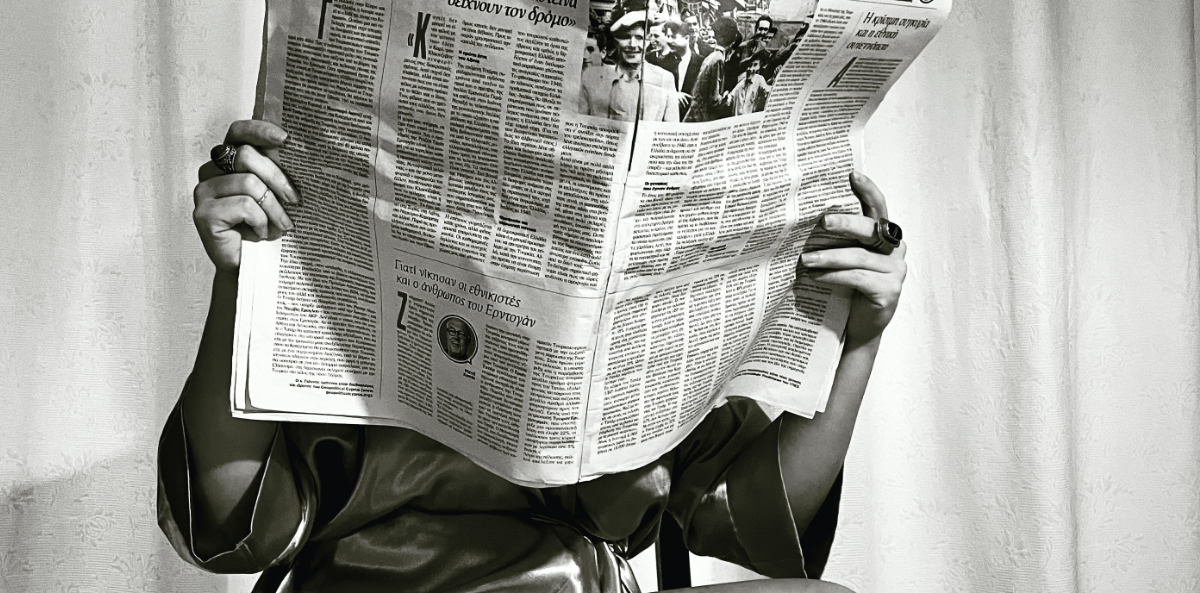 A person holding a newspaper in black and white. This represents Joan's key takeaways of 2023.